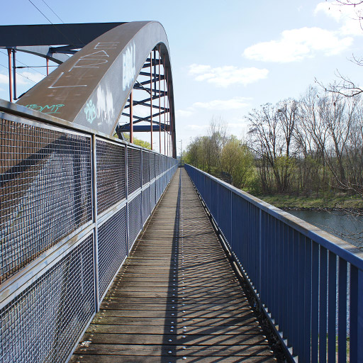 A footpath on a railroad bridge.