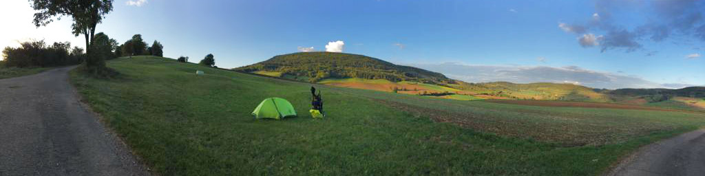Tent on a green hill.