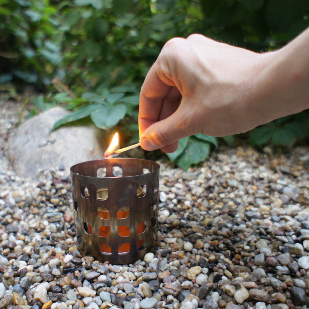 Lighting an alcohol stove with a match.